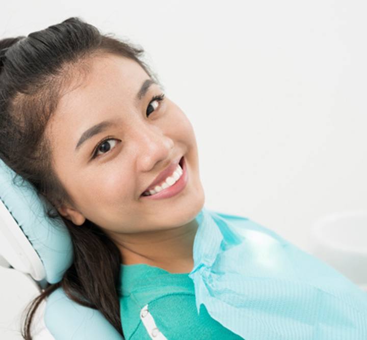Female patient sitting back in dental chair, visiting Delta Dental dentist in San Antonio