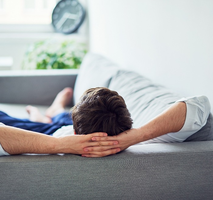 Man relaxing on his sofa at home