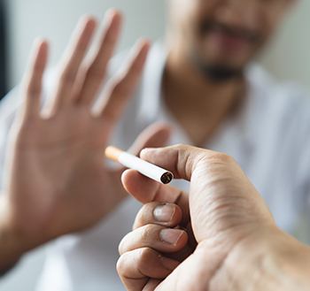 Man declining the offer of a cigarette