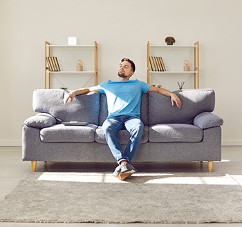 Man resting on his sofa at home