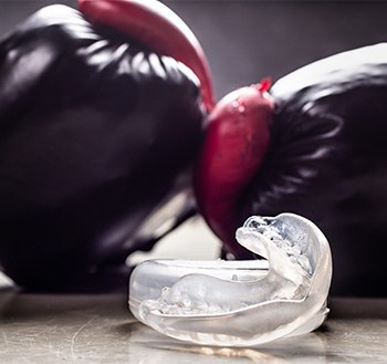 Mouthguard in front of boxing gloves