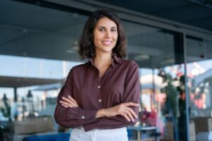 Smiling, confident professional woman in business setting 