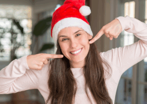 a patient smiling after teeth whitening treatment during the holidays